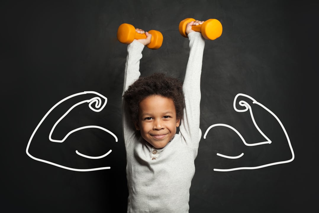 Strong black child boy with dumbbells