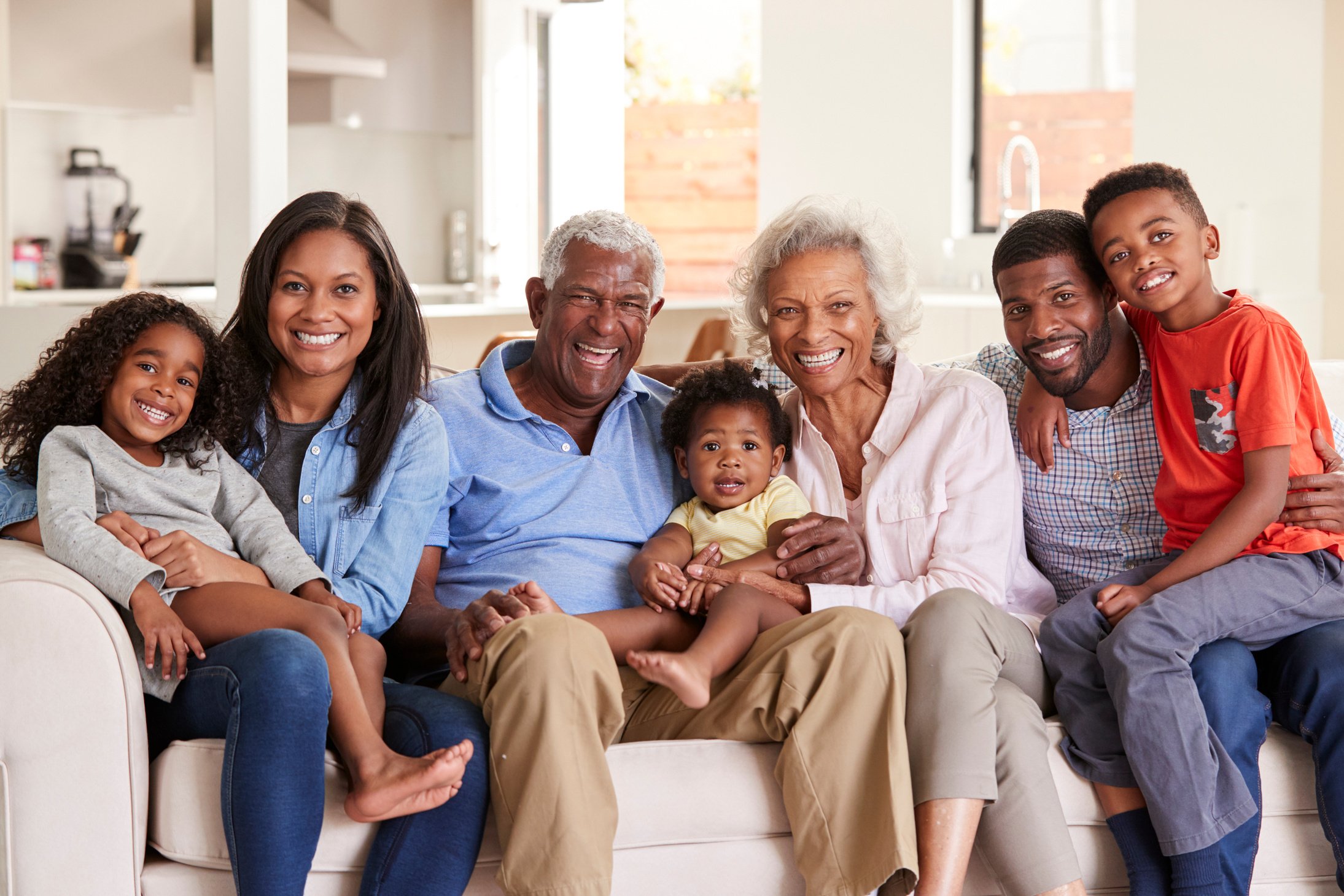 Multi-Generation Family Sitting on Sofa at Home